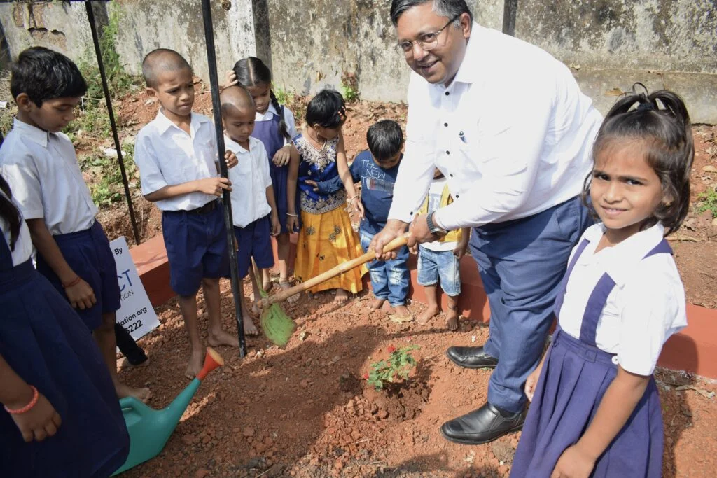 Dr. Ashwin Fernandes with students in the garden